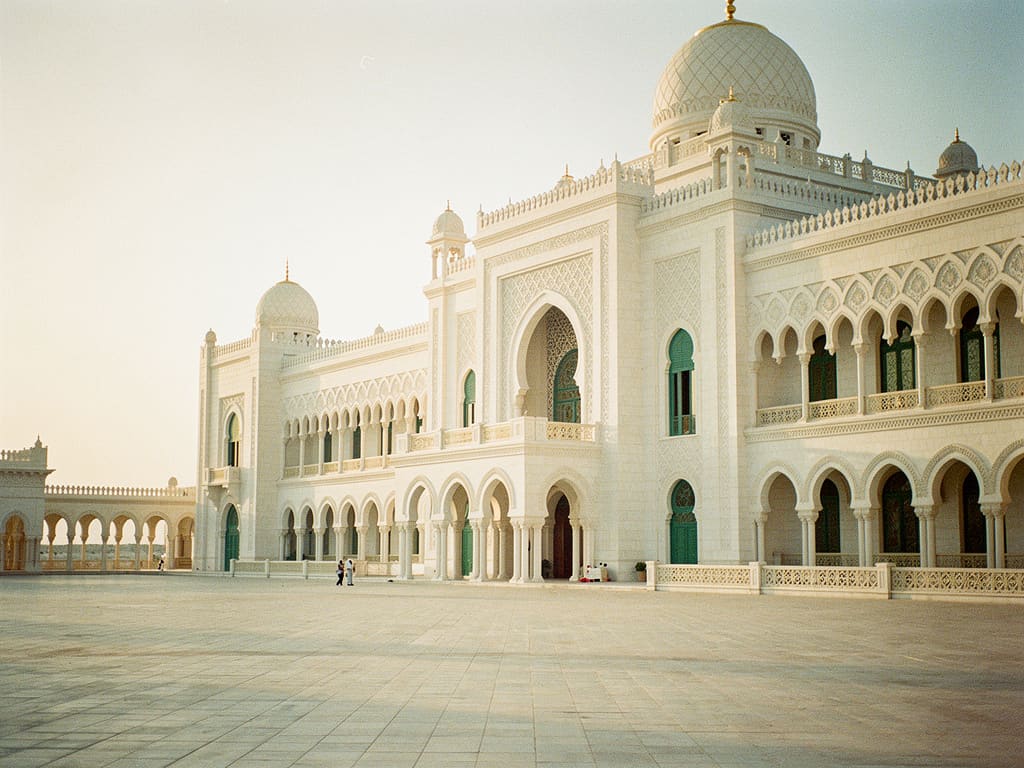 Ornate white stone palace in Abu Dhabi in late-afternoon light